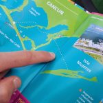 Map with finger pointing to ocean